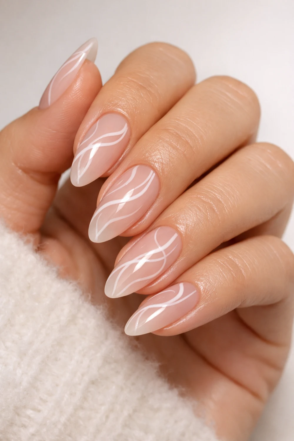 Abstract White Swirl Almond Nails For A Trend-Forward Guest